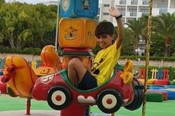 a child riding on a carousel